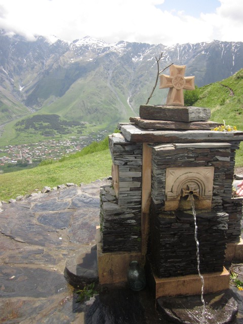 fountain with Kazbegi town below
