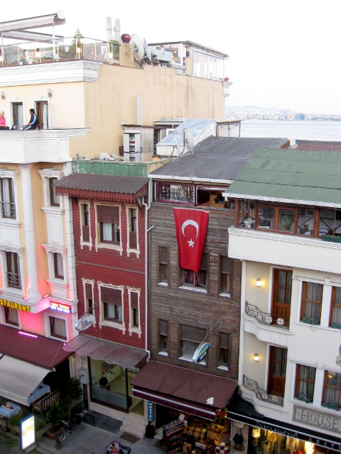 looking down from a rooftop restaurant at the street