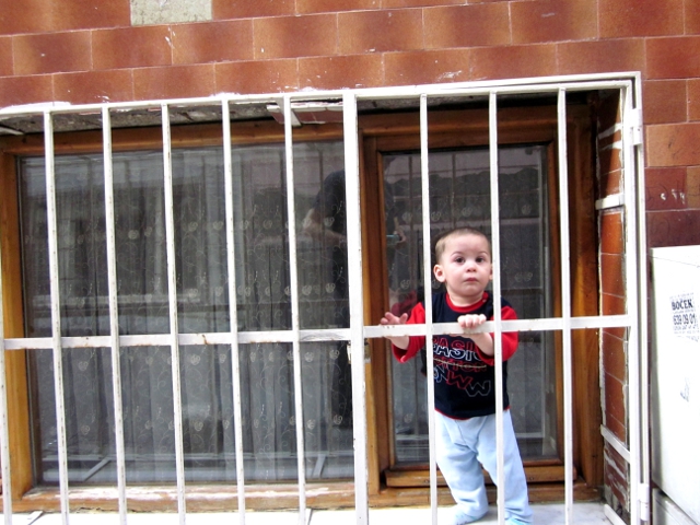 toddler in barred window